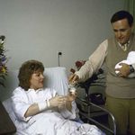 "US Atty. Rudolph Giuliani w. wife Donna and son Andrew Harold at NY Hospital." 1986.
